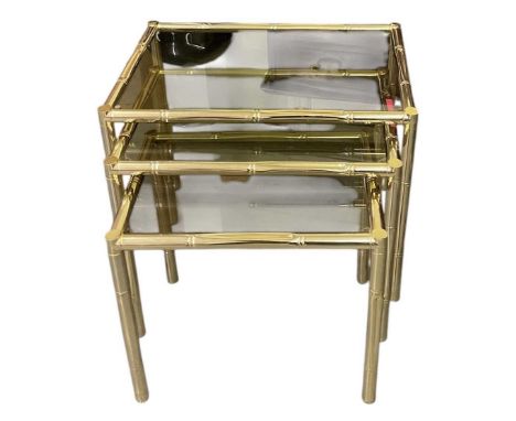 A modern nest of three brass bamboo style glass topped coffee tables, the largest 42.5 x 57.5cm, and a mid century chrome fra