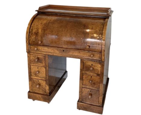 A Victorian burr walnut roll top desk enclosing fitted interior, with pull-out slide with brown leather gilt tooled inset top