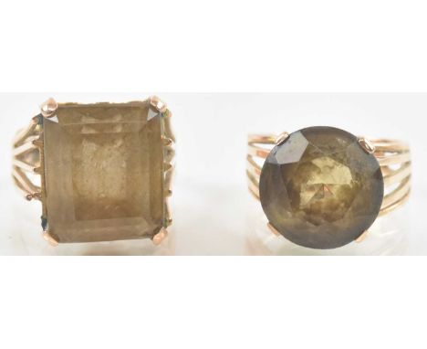 A yellow metal topaz set ring, the square cut central topaz approx 6ct, size J/K, and a yellow metal topaz set ring, the cent