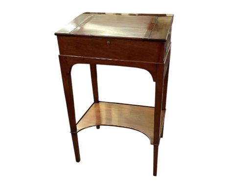 A reproduction mahogany clerk's desk on stand, with hinged lid enclosing fitted interior, with gilt tooled red leather insert