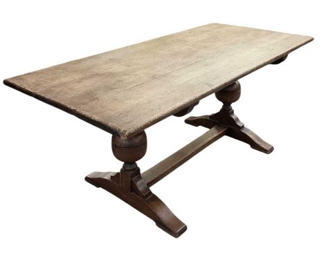 An early 20th century oak plank top refectory table, on carved acorn supports, top measures 183 x 83cm.