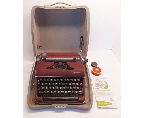 A VINTAGE OLYMPIA SM2 TYPEWRITER IN TRAVEL CASE WITH INSTRUCTIONS, BRUSH, SPARE RIBBON ETC