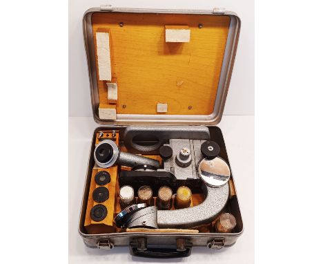 A VINTAGE MICROSCOPE IN A STEEL CASE