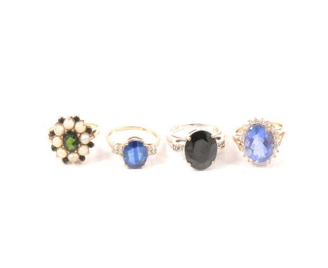 Four blue and green stone dress rings, a sapphire and white stone ring, the oval mixed cut sapphire, 11.9mm four claw set fla