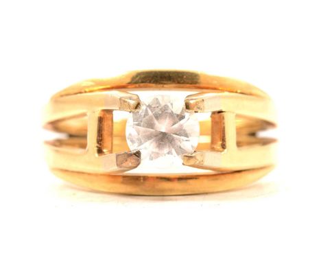 A gentleman's synthetic white stone solitaire ring, the 7.2mm diameter stone set with four raised claws in an all yellow meta