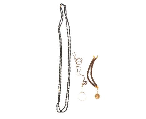 Two ropes of 5.5mm black glass beads with small bead spacers, each necklace 120cm; a woven hair 7mm gauge twisted necklace wi