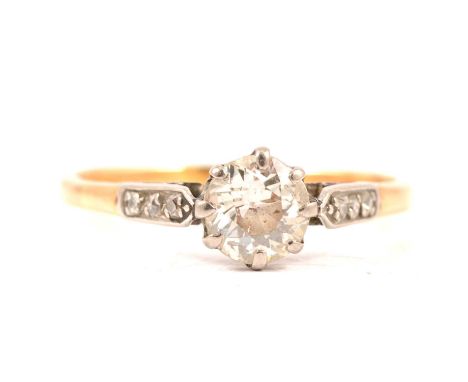 A diamond solitaire ring, the brilliant cut stone claw set in a yellow and white metal mount ring size Q, three rose cut diam