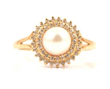 A cultured pearl and diamond dress ring, the 6.8mm pearl peg set on a 9 carat yellow gold mount and surrounded by a double ci