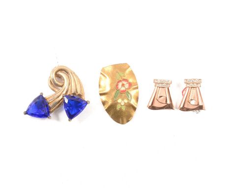 Twenty-seven vintage gilt metal and paste / enamel dress clips, brooches and belt clasps; a 1930s Arts and Crafts-style gilt 