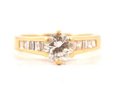 A diamond solitaire ring, the brilliant cut stone claw set in an all yellow metal mount ring size P, five baguette/square cut