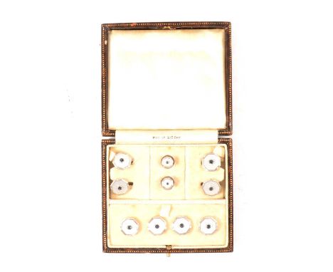 A cased set of cufflinks and dress studs, white guilloche octagonal faces mounted in white metal stamped 9ct, the cufflinks w
