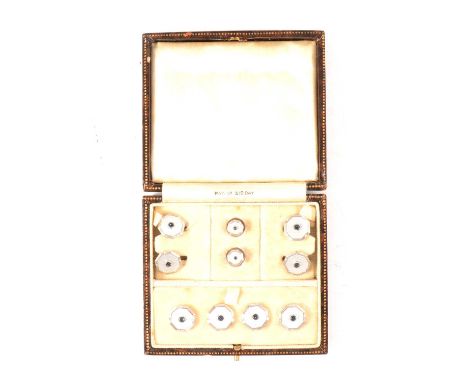 A cased set of cufflinks and dress studs, white guilloche octagonal faces mounted in white metal stamped 9ct, the cufflinks w