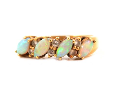 An opal and diamond half hoop ring, four marquise shaped cabochon cut opals claw set on an angle and spaced by three pairs of