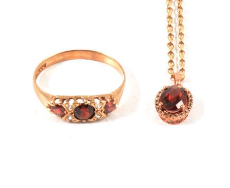 Two 9 carat yellow gold garnet pendants, one set with two small diamonds, on oval trace link chains 45cm long, a seven stone 