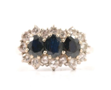 A sapphire and diamond triple cluster ring size N, three oval mixed cut sapphires surrounded by sixteen brilliant cut diamond