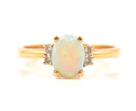 An opal and diamond dress ring, an oval cabochon cut opal 8x6mm four claw set with a pair of brilliant cut diamonds verticall