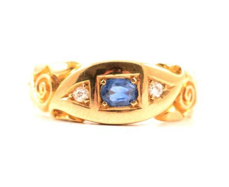 A sapphire and diamond ring, the oval mixed cut sapphire and two old cut diamonds pip claw set in an Edwardian style 18 carat