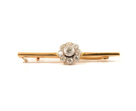 A diamond cluster bar brooch, nine old brilliant cut stones pip claw and collet set to the centre of a 40mm yellow and white 
