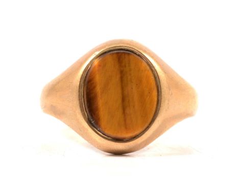 A 9 carat yellow gold 11x8mm tigers eye signet ring size U, Sheffield 1980, gross weight 5,5g.