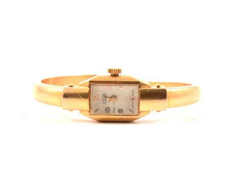 Rotary - a lady's cocktail bangle watch, 13x9mm white baton dial with even Arabics in a yellow metal tonneau shaped case numb