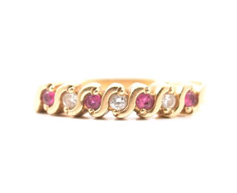 A ruby and diamond half eternity ring, four rubies and three brilliant cut diamonds set in a 9 carat all yellow gold half ete