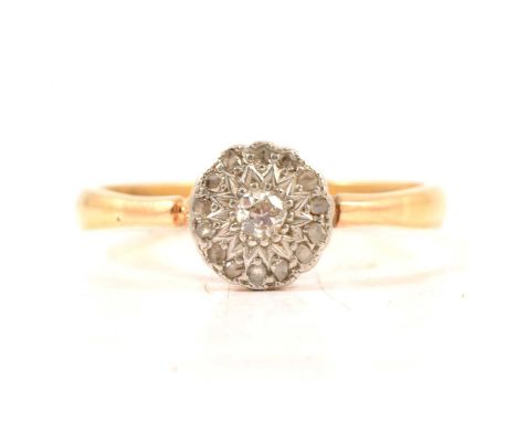 A diamond cluster ring, a brilliant cut diamond surrounded by fourteen rose cut diamonds pave set in a yellow and white metal