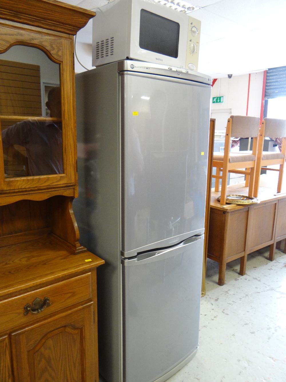 An LG Express Cool upright fridge freezer in grey together with a