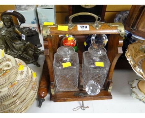 A two-bottle vintage tantalus (damage to one decanter)