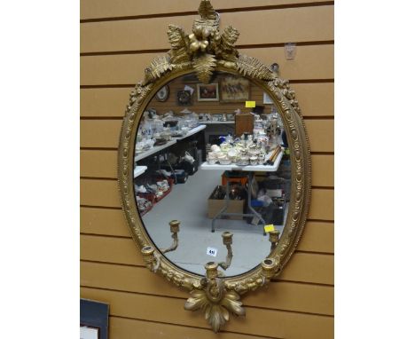 An antique gilt framed mirror with candelabra