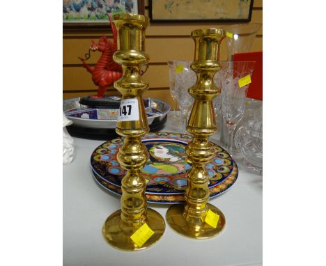 A pair of unusual heavy brass candlestick holders