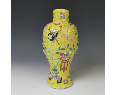 A late 19thC Chinese famille jaune baluster Vase, the yellow ground with enamel decorations in relief depicting vases and urn