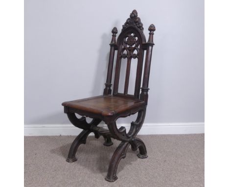 A Gothic style oak Hall Chair, with carved and pierced back, above a square panel seat raised on carved curved legs, W 48 cm 