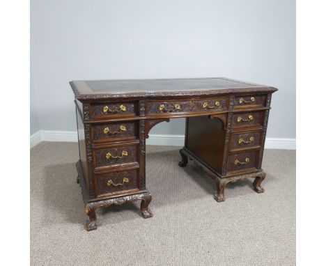 An early&nbsp;Edwardian mahogany carved pedestal Desk, single drawer above knee hole, flanked by a four drawers to each side,