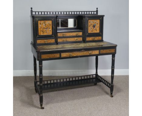 An Aesthetic movement ebonised kneehole Desk, with gilt decoration and painted panels depicting birds , pierced removable gal