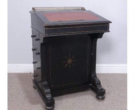 A Victorian ebonised Davenport, the top with three quarter brass gallery and red skiver, above four dummy and four real drawe