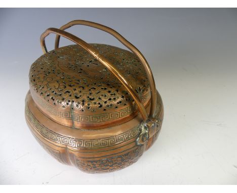 A Chinese copper Hand Warmer, the body of lobed oval form with six panels of decoration depicting buildings within a wooded l