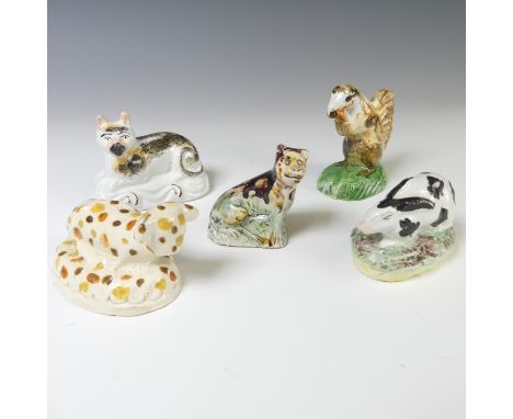 A small 19thC prattware figure of a Calf, dotted in ochre, orange and umber, together with a Staffordshire pottery squirrel, 