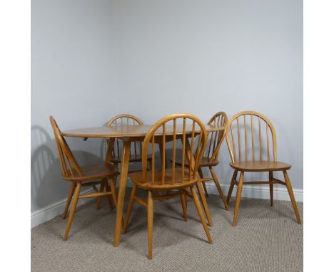 A 1960s Ercol blond elm drop-leaf Table, having oval fall leaves and raised on slightly tapering supports together with five 