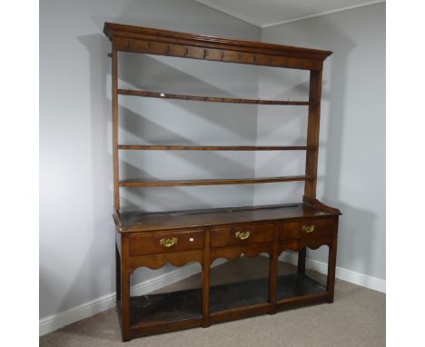 A George III oak Dresser,&nbsp;having two shelves, iron hanging hooks to the upper plain frieze, the base with three drawers 