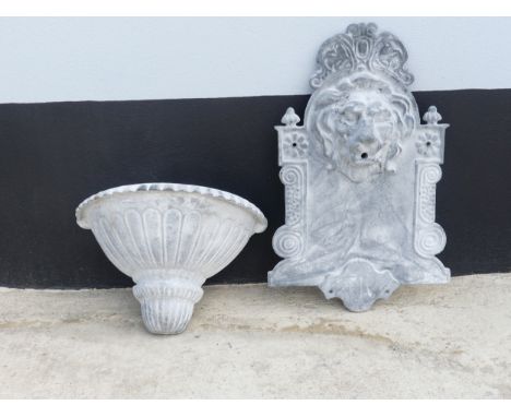 A wall-mounted lead water Fountain in the shape of a lions head, above basin/reservoir, W 42 cm x H 86 cm x D 20 cm. 