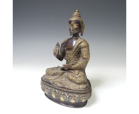 An antique Sino-Tibetan gilt bronze figure of the Buddha, seated in&nbsp;dhyanasana on a lotus base, wearing a robe decorated
