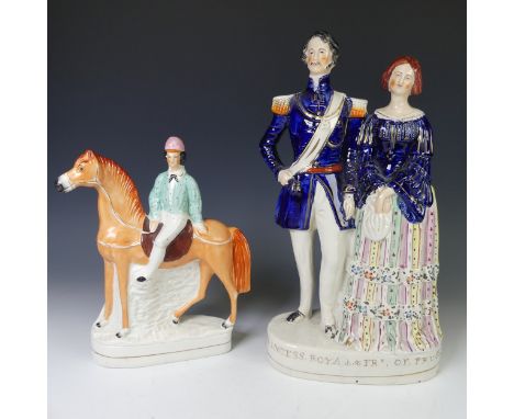 An antique Staffordshire pottery figure of a Jockey on Horseback, the rider with pink hat and blue blouse, on gilt line plint