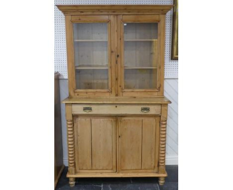 An Antique pine Dresser with turned bobbin decoration&nbsp;to base edges, moulded cornice above two glazed cabinet doors, enc