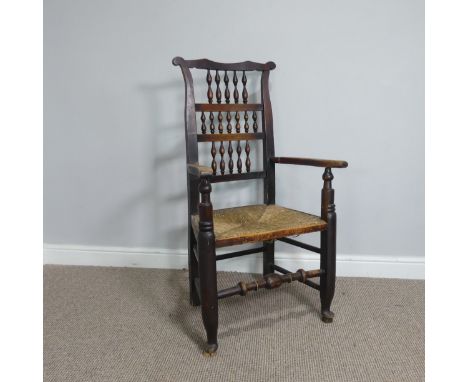 An 18thC style oak Lancashire ladder and bobbin back open Armchair, with rush seat, on turned supports, W 57 cm x H 103 cm x 