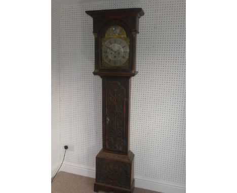 W. Fletcher, Leeds, a carved oak 8-day longcase clock with two-weight movement striking on a bell, the 12-inch arched brass d