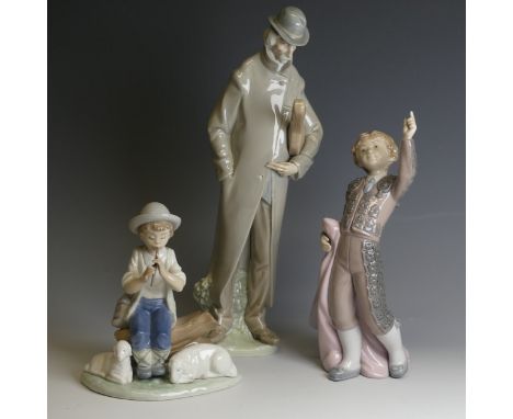 A Lladro porcelain figure of 'Old Man with Violin', H 35cm, together with a Lladro figure of a young boy, H 24cm, and a Nao f