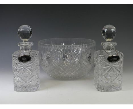 A pair of cut crystal glass Decanters, of rectangular form with star cut decoration, circular stoppers, one with small chip t