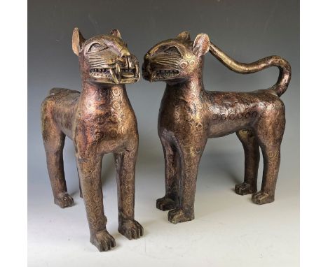 A large pair of African, Benin Leopards, patinated bronze with engraved circular design, one with raised tail and the other l