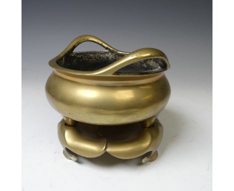 A Chinese gilt bronze Tripod Censer, of typical circular form with two loop handles, raised on three conical supports, seal m