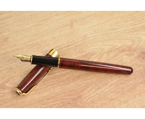 A boxed Parker Sonnet converter fill fountain pen in Chinese red laque with gold trim having Parker 18K 750 nib